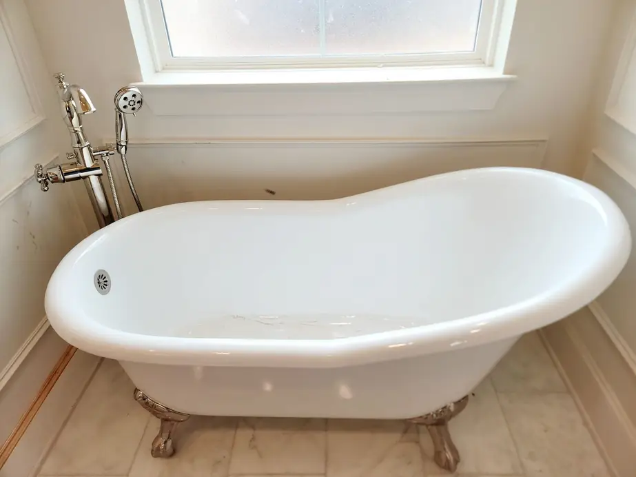 Clawfoot slipper tub under a window