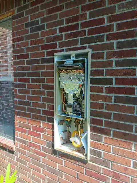 Gas and utility box set into a brick wall