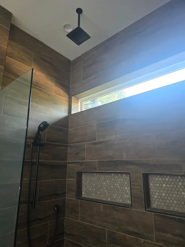Dark tile shower with a rain head